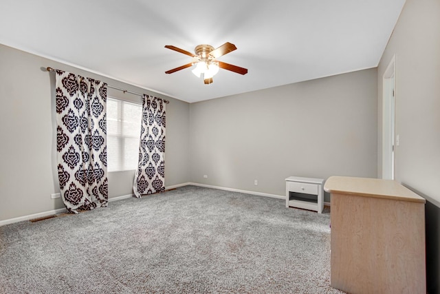 carpeted spare room with ceiling fan