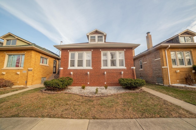 bungalow-style house with a front yard