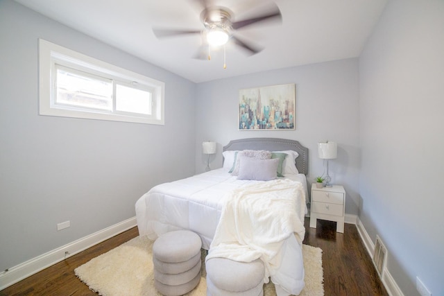 bedroom with ceiling fan and dark hardwood / wood-style flooring