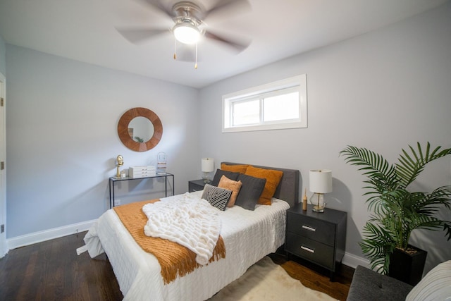 bedroom with dark hardwood / wood-style flooring and ceiling fan