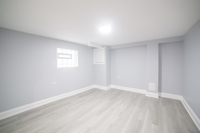 basement with light hardwood / wood-style flooring