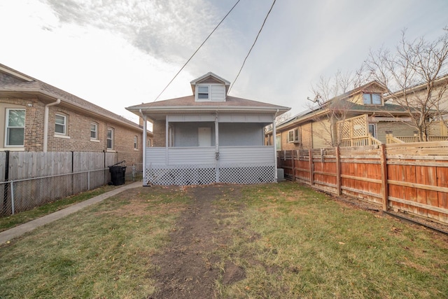 back of property featuring a yard