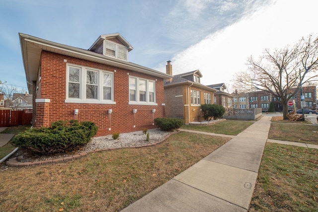 bungalow-style house with a front yard