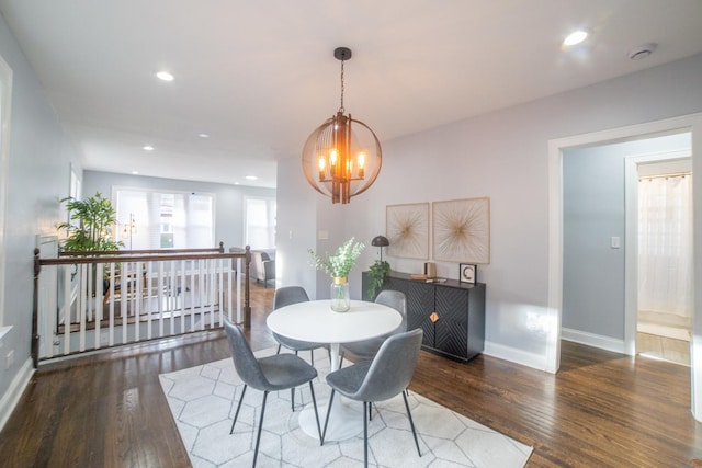 dining space featuring dark hardwood / wood-style flooring and a notable chandelier