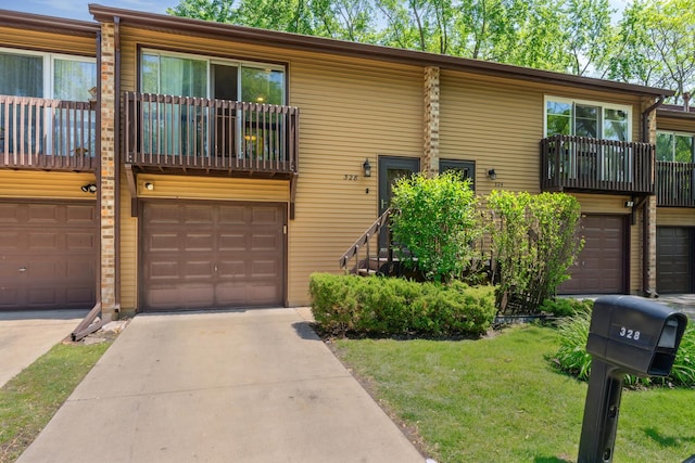 328 Ottawa Dr, Bolingbrook, IL 60440 - view of front of property with a balcony, an attached garage, a front yard, and concrete driveway