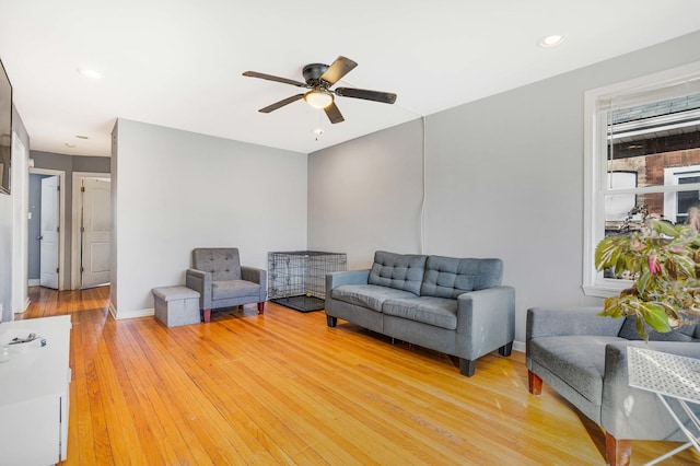 living room featuring hardwood / wood-style flooring and ceiling fan