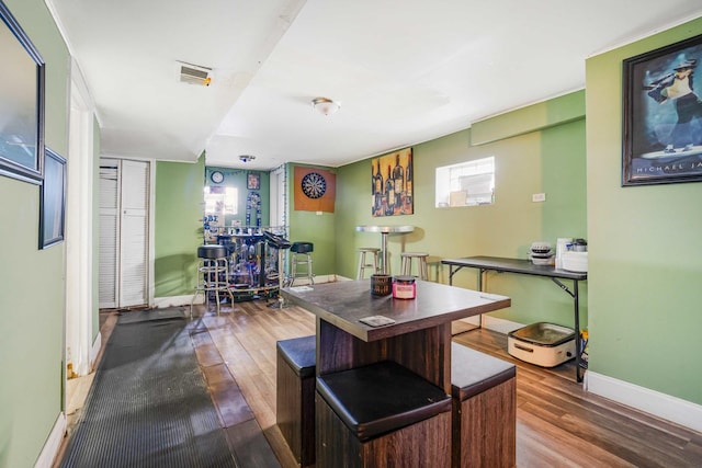 office space featuring hardwood / wood-style flooring and bar area