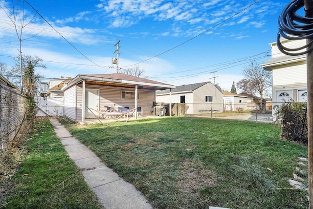 rear view of house featuring a yard