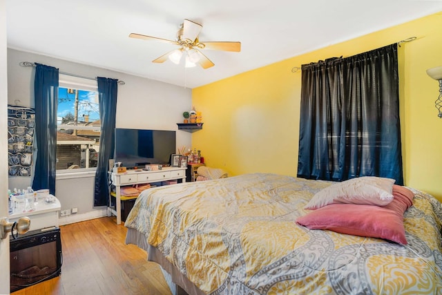 bedroom with ceiling fan and light hardwood / wood-style flooring