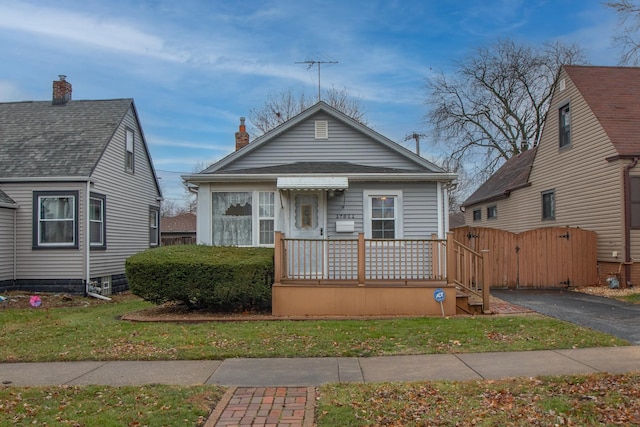 bungalow-style home with a front lawn