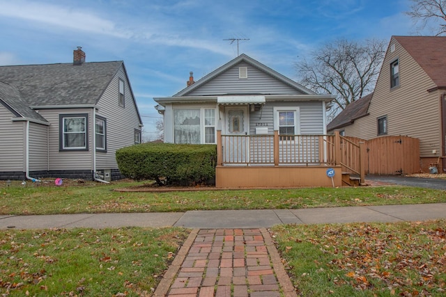 bungalow-style house with a front lawn