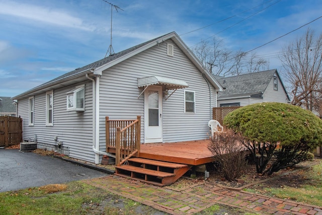 rear view of house featuring central AC and a deck