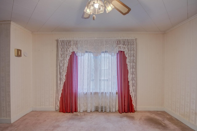 spare room featuring carpet flooring, ceiling fan, and crown molding