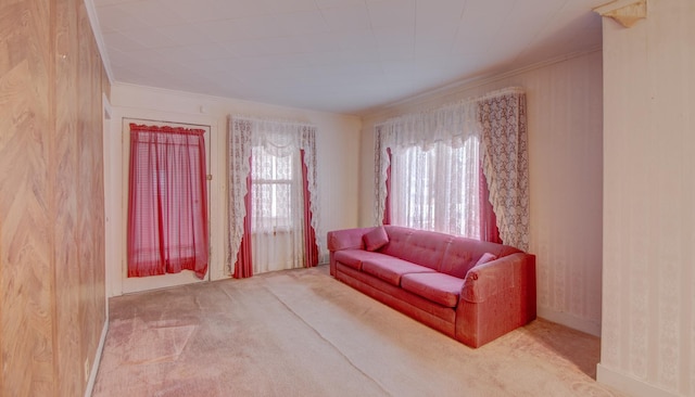 carpeted living room with crown molding and wood walls