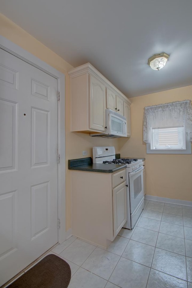 kitchen with light tile patterned floors and white appliances