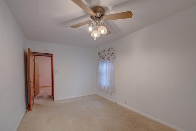 unfurnished room with light colored carpet and ceiling fan