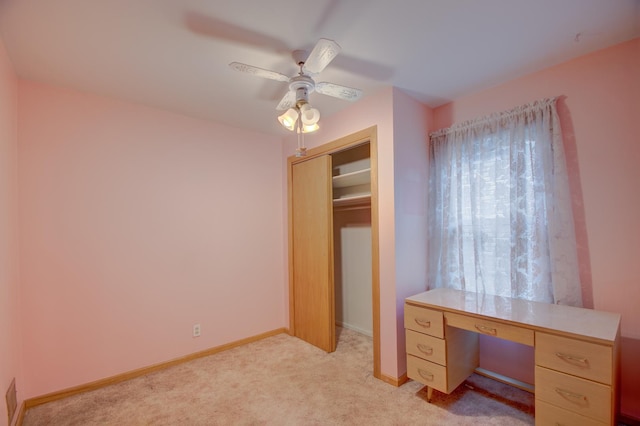 office featuring light carpet and ceiling fan