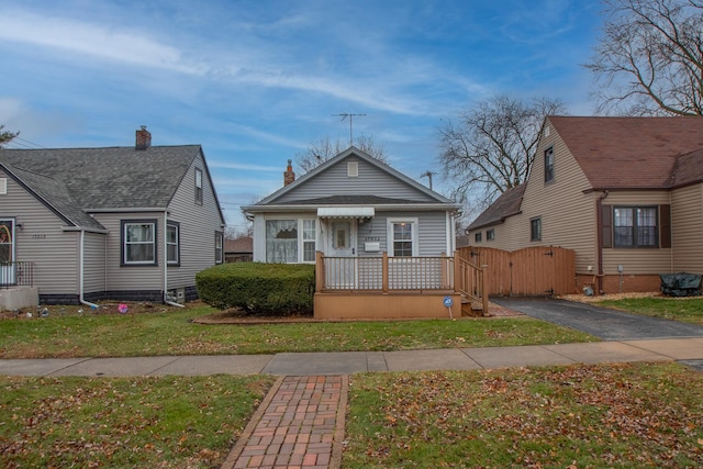 bungalow-style home with a front yard