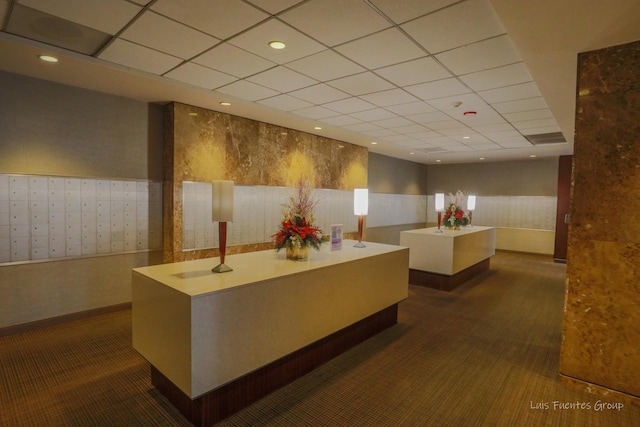 reception with wallpapered walls, mail area, a drop ceiling, and recessed lighting