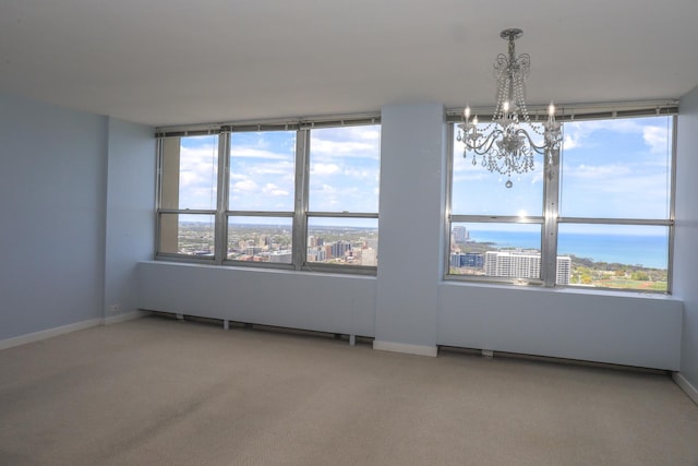 unfurnished dining area with a chandelier, carpet flooring, and baseboards