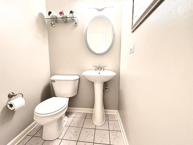 bathroom featuring sink, tile patterned floors, and toilet