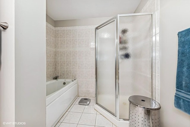 bathroom featuring tile walls, tile patterned flooring, and shower with separate bathtub