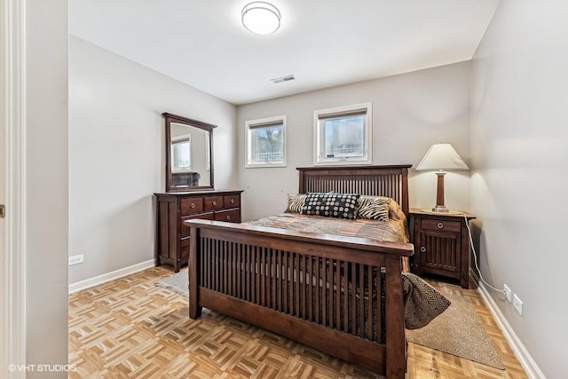 bedroom with light parquet flooring