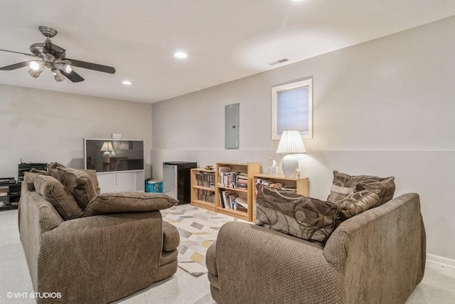 living room with electric panel, light colored carpet, and ceiling fan