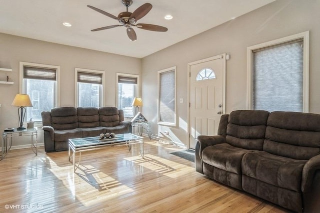 living room with ceiling fan, light hardwood / wood-style flooring, and plenty of natural light