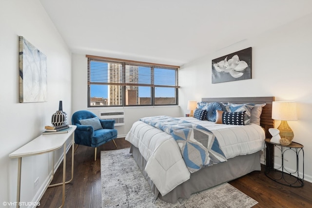 bedroom with dark wood-type flooring and a wall mounted AC