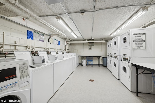 washroom with washing machine and dryer and stacked washer and dryer