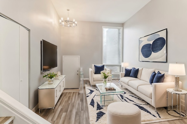 living room featuring a notable chandelier and light hardwood / wood-style floors