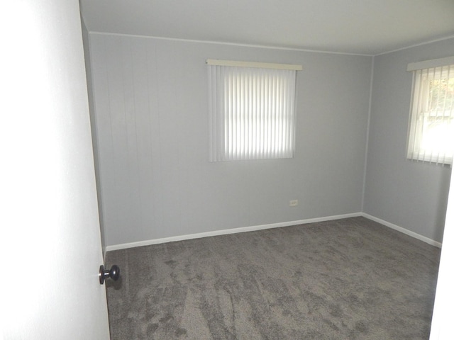 empty room featuring dark carpet