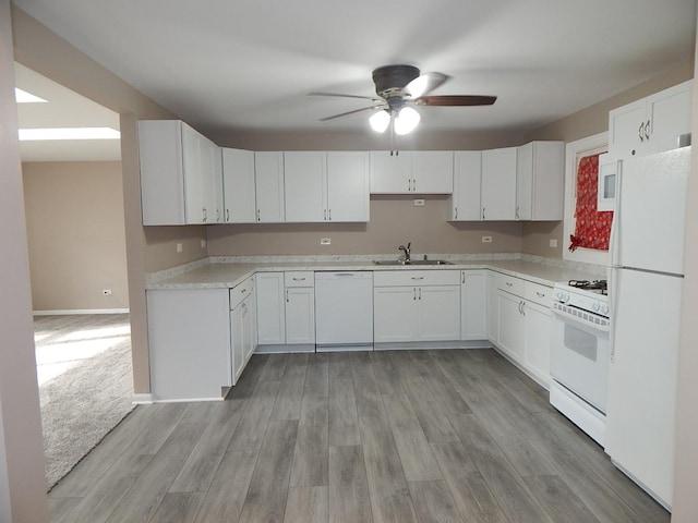 kitchen featuring white cabinets, white appliances, sink, and light hardwood / wood-style flooring