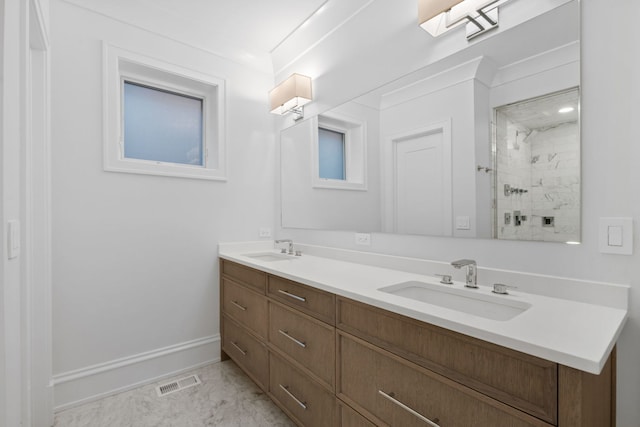 bathroom featuring tiled shower, vanity, and ornamental molding