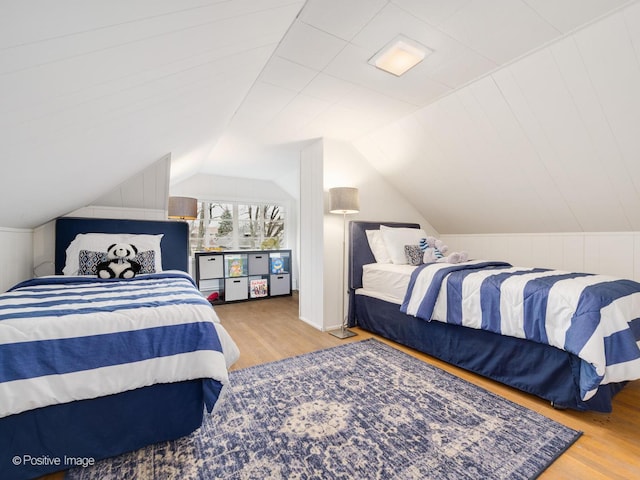 bedroom featuring hardwood / wood-style floors and vaulted ceiling