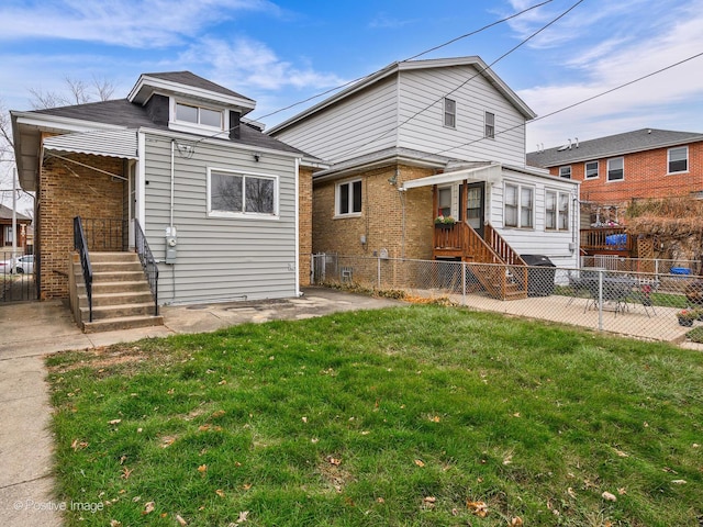 rear view of property featuring a yard