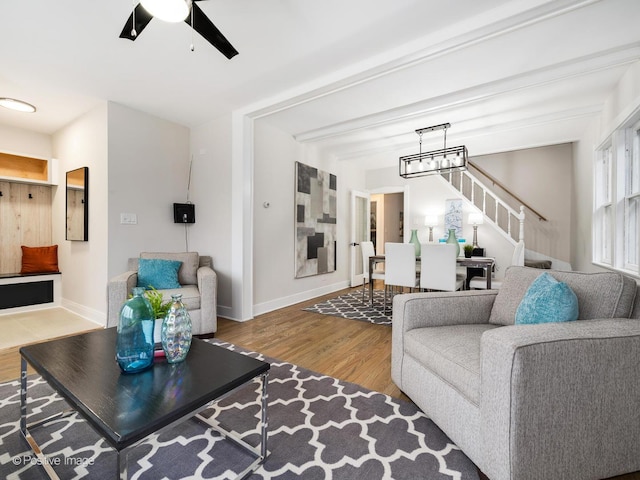 living room featuring hardwood / wood-style floors and ceiling fan