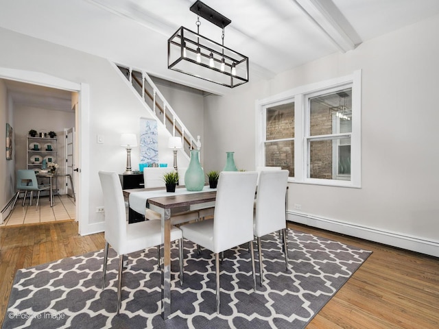 dining room with baseboard heating and dark wood-type flooring