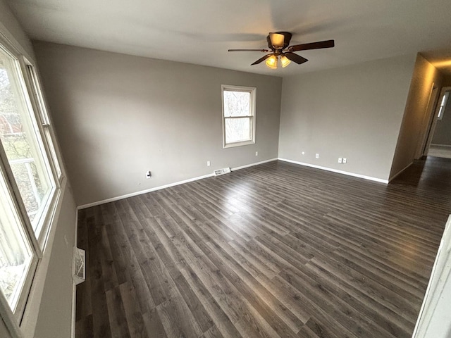 spare room featuring ceiling fan and dark wood-type flooring