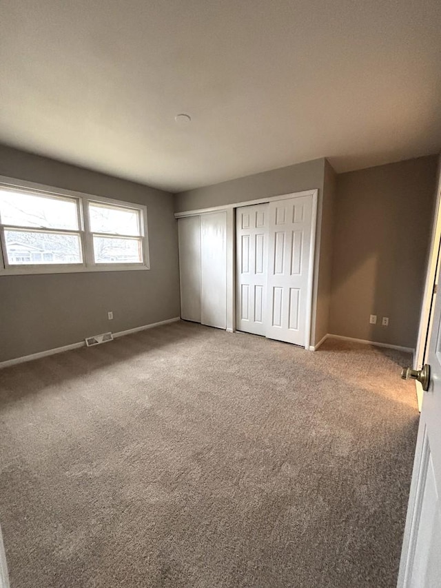 unfurnished bedroom with carpet flooring