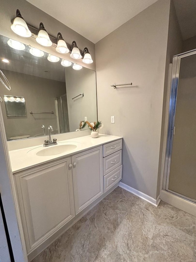 bathroom featuring vanity and a shower with shower door