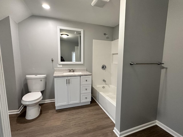 full bathroom featuring hardwood / wood-style flooring, toilet, shower / washtub combination, and lofted ceiling