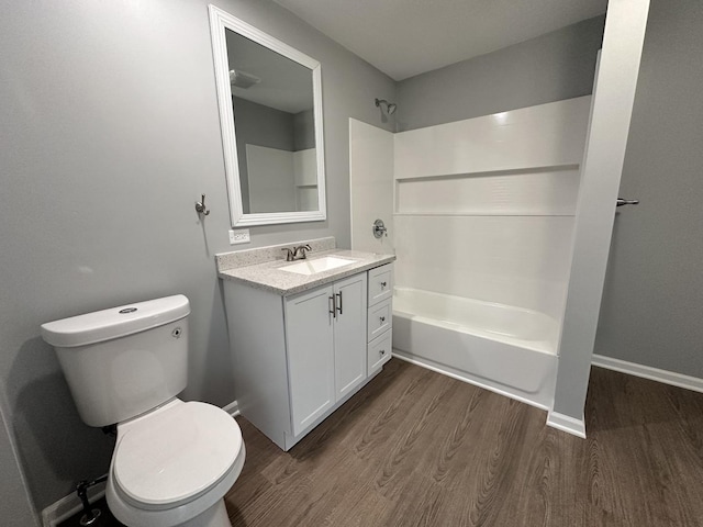 full bathroom with bathtub / shower combination, hardwood / wood-style floors, vanity, and toilet