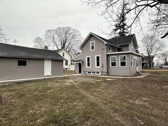 rear view of property with a yard