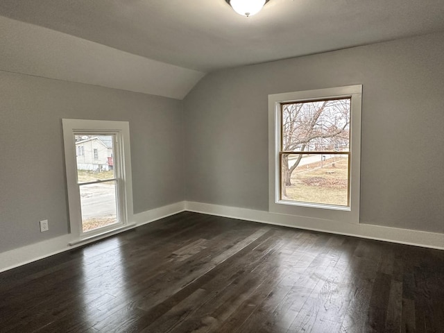 bonus room featuring a wealth of natural light, dark wood-type flooring, and vaulted ceiling