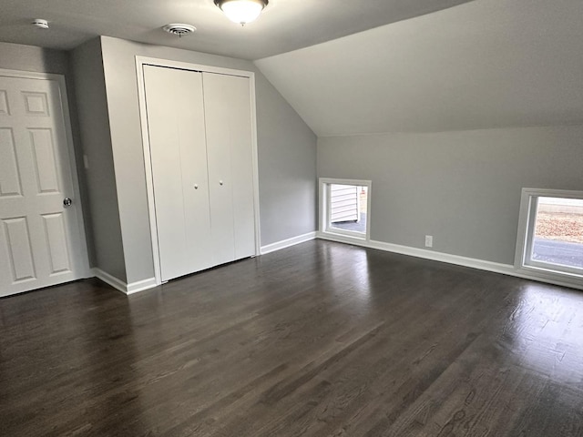 bonus room featuring lofted ceiling and dark hardwood / wood-style floors