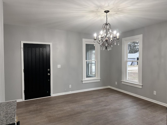 foyer featuring dark hardwood / wood-style flooring and a chandelier