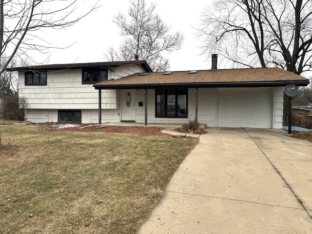 tri-level home with a garage and a front lawn