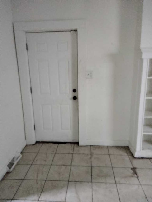 doorway to outside featuring light tile patterned flooring